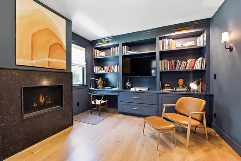 a living room with furniture fireplace and a flat screen tv