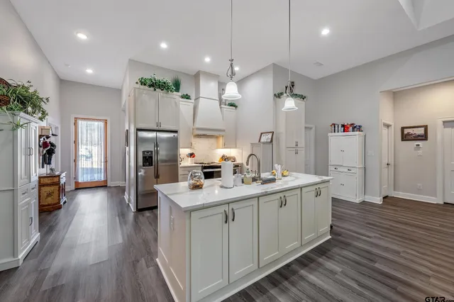 a kitchen with counter top space a sink cabinets and stainless steel appliances
