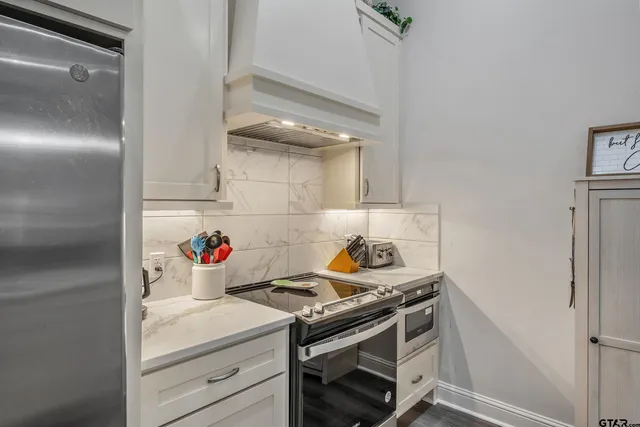 a kitchen with a stove and cabinets