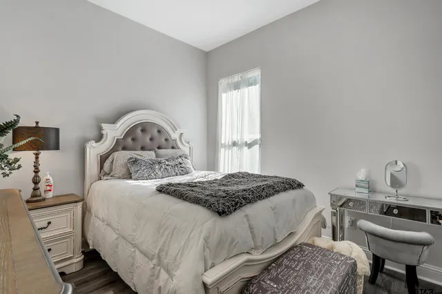 a bedroom with a bed and a dresser in it