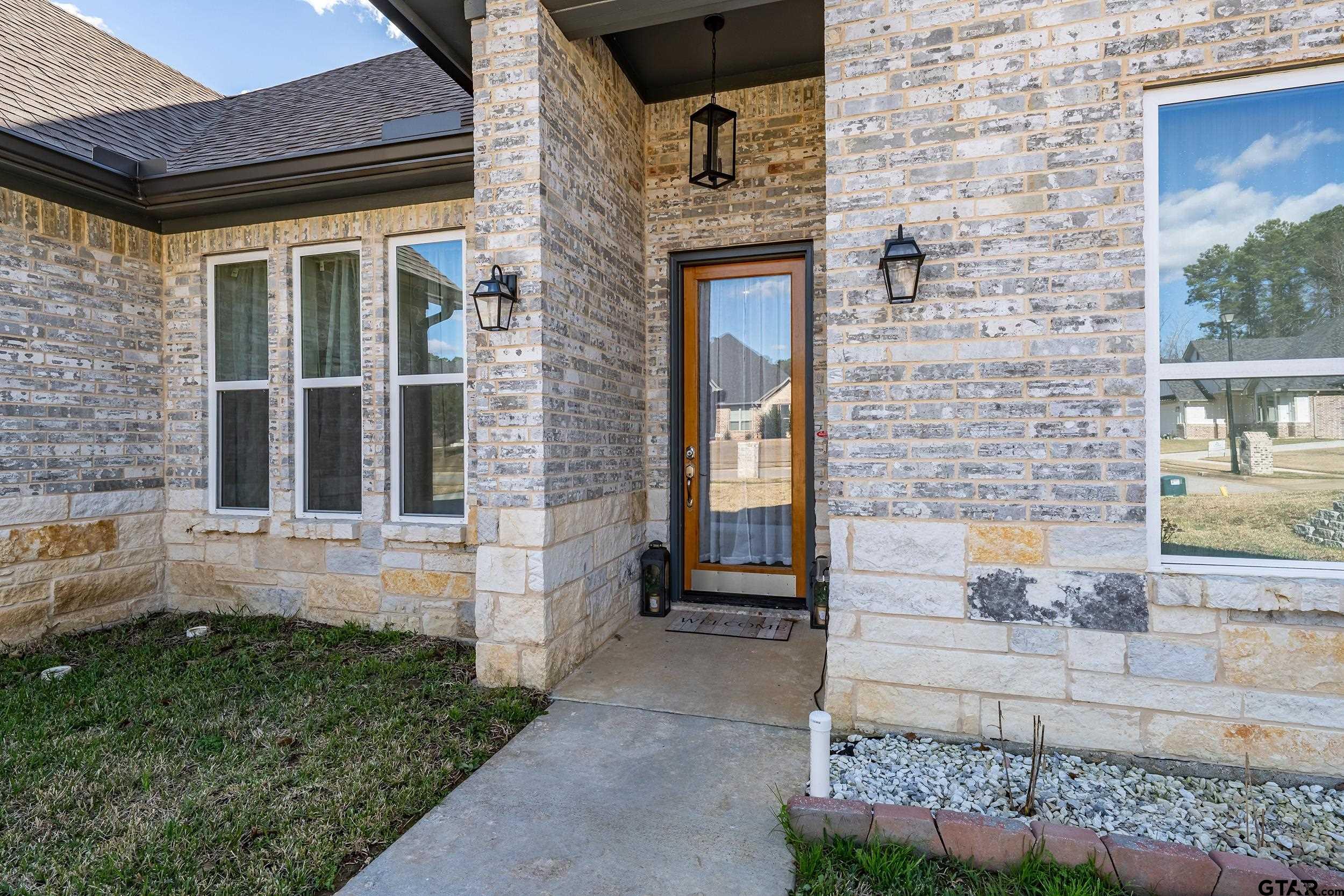 9109 Long Branch Tyler, TX 75703 - Photo 2 of 34 a front view of a house with a yard