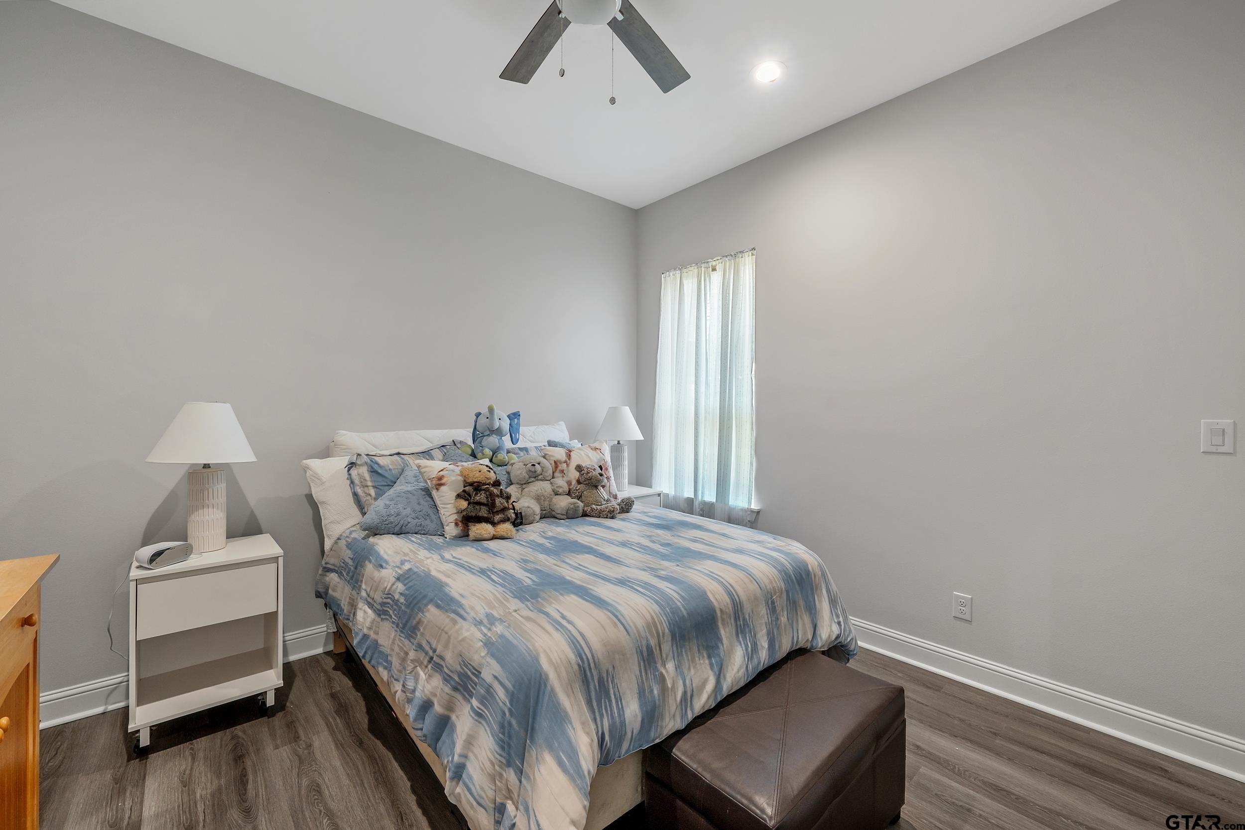 9109 Long Branch Tyler, TX 75703 - Photo 21 of 34 a bedroom with a bed and a chair