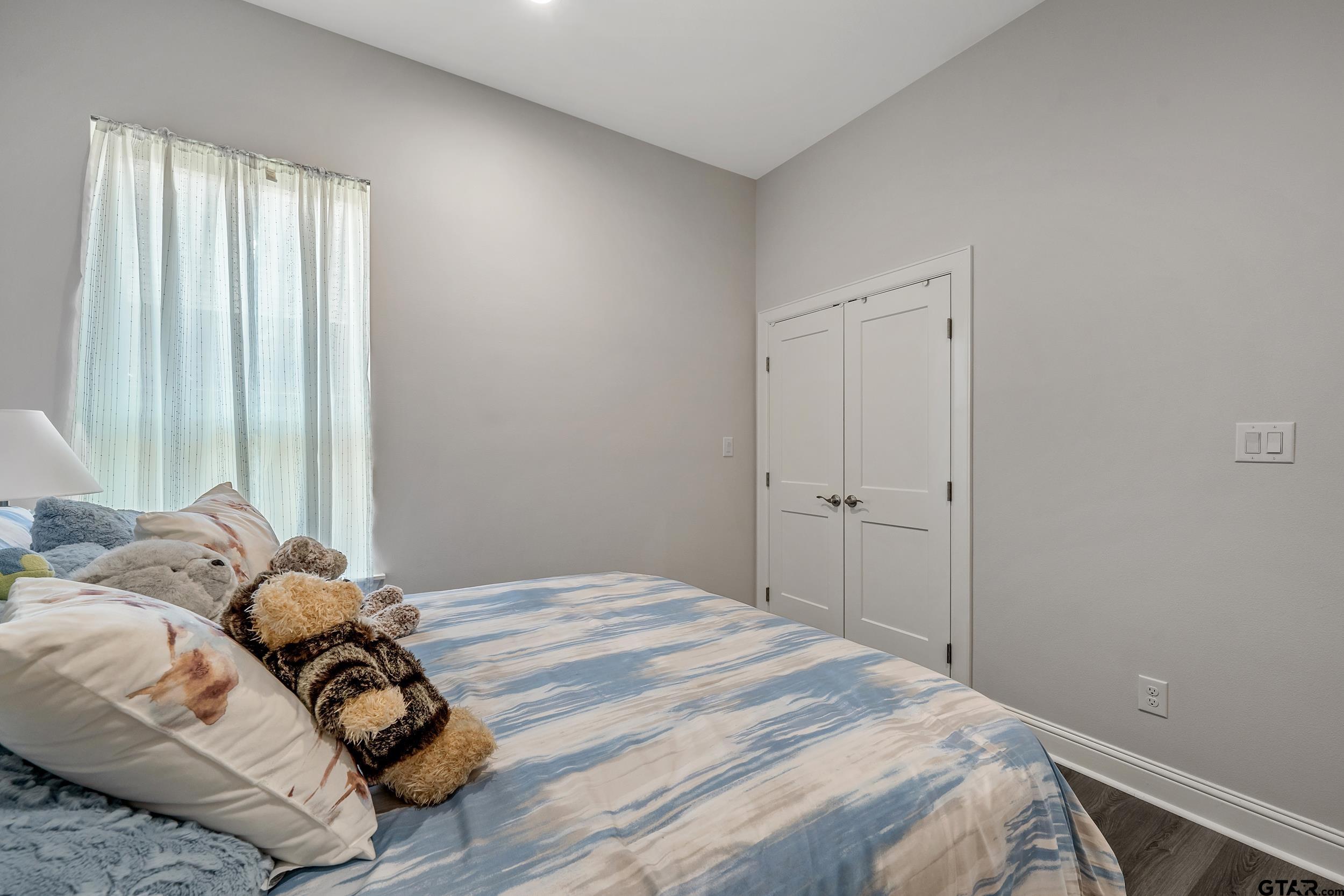 9109 Long Branch Tyler, TX 75703 - Photo 22 of 34 a bedroom with a bed and a window