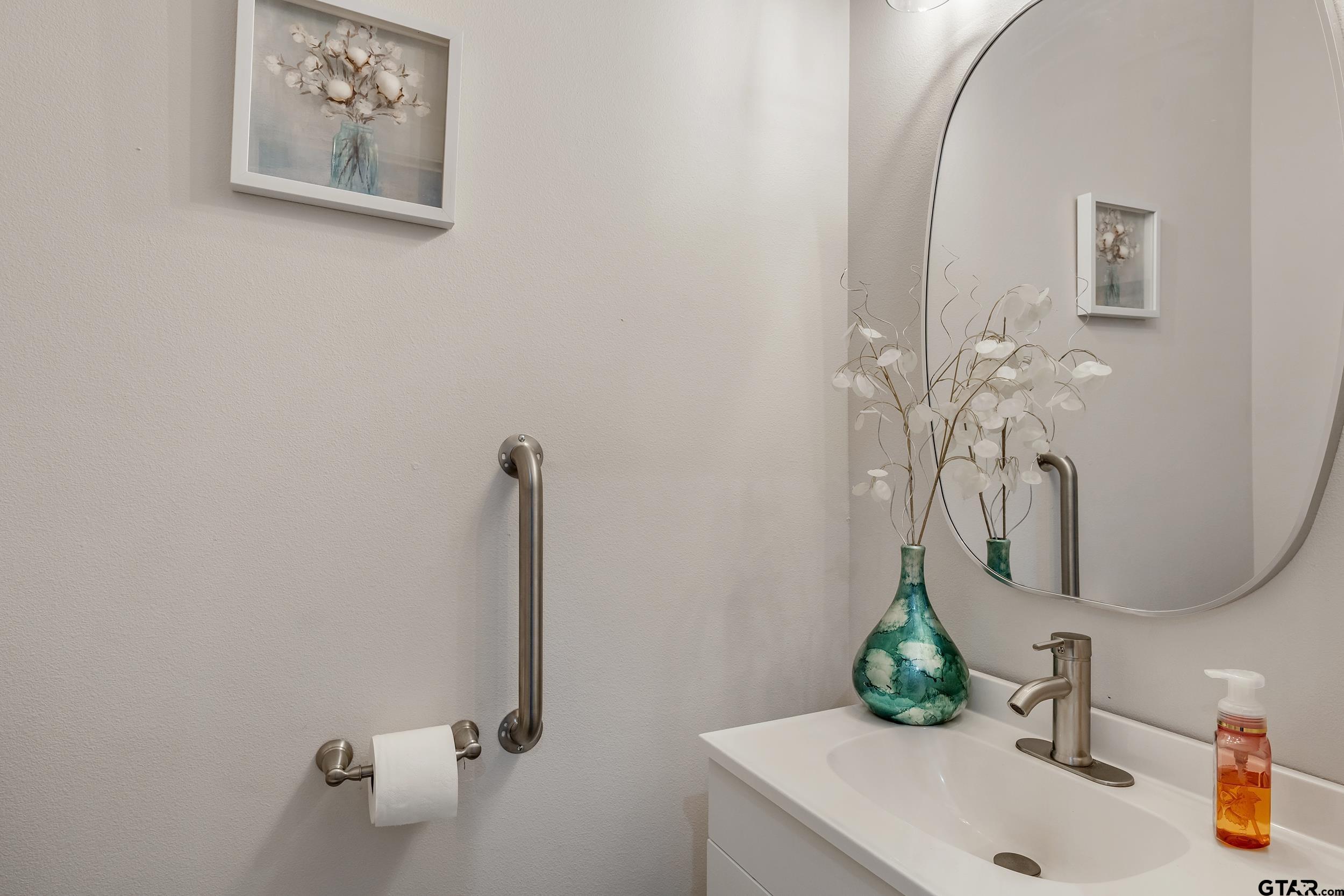9109 Long Branch Tyler, TX 75703 - Photo 23 of 34 a bathroom with a sink and a mirror