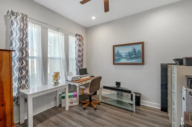 a view of a workspace with furniture and a window