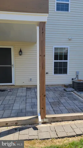 a view of a patio with table and chairs under an umbrella