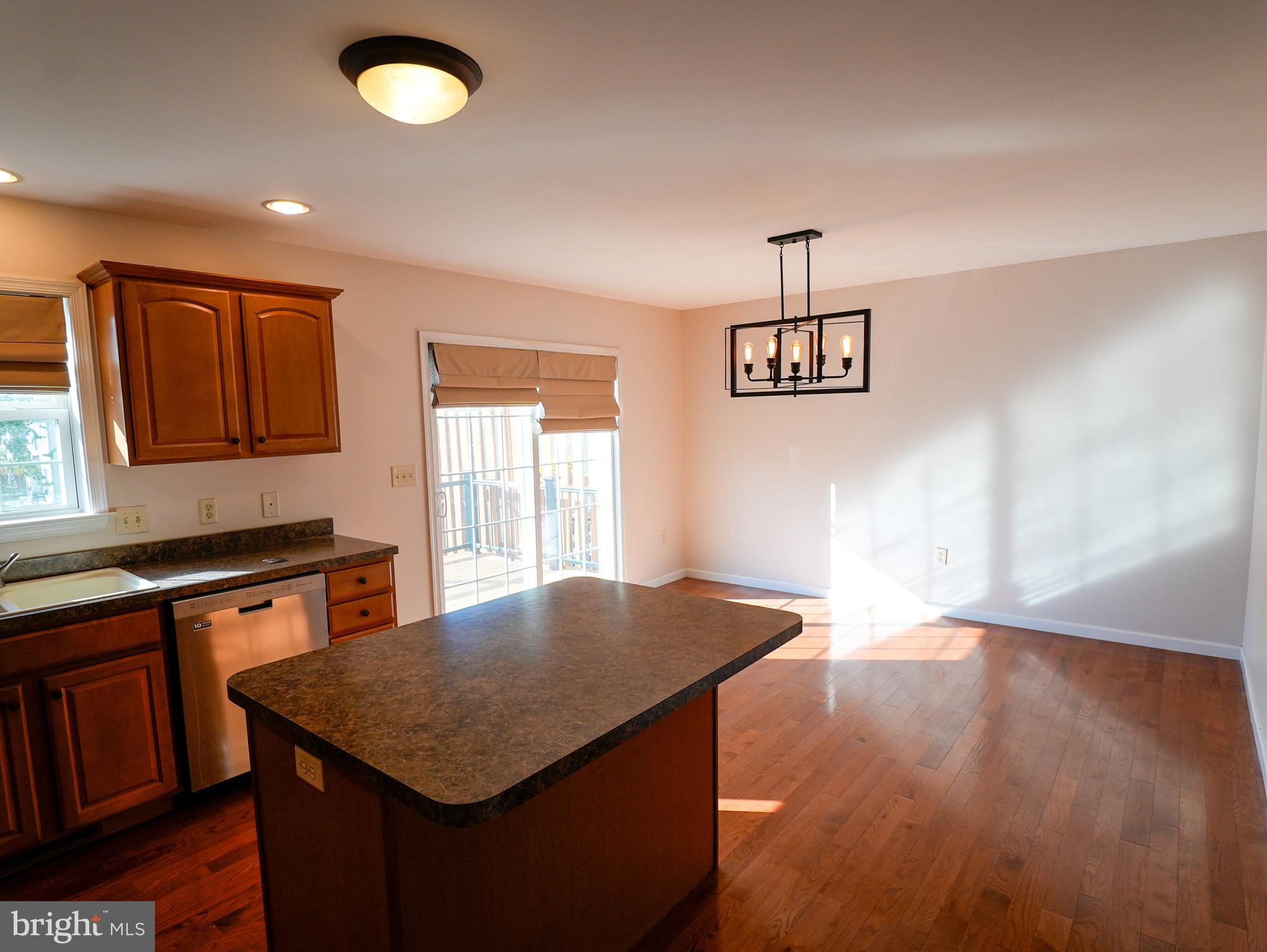 160 Mapleton Drive Harrisburg, PA 17112 - Photo 27 of 39 a kitchen with stainless steel appliances granite countertop a stove top oven a sink dishwasher and microwave with wooden floor
