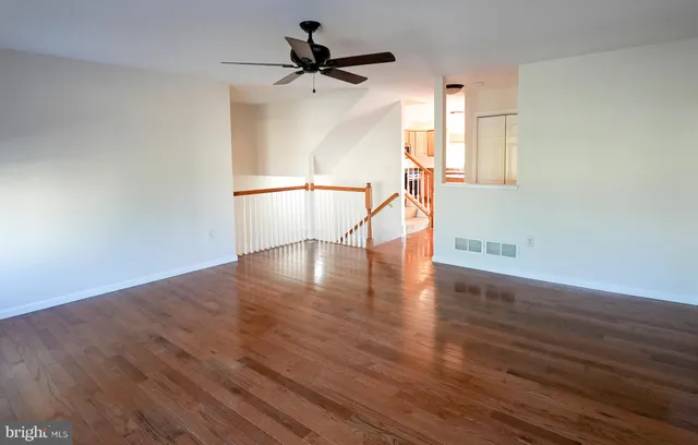 a view of a livingroom with wooden floor and a window