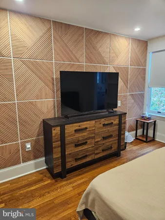 a bedroom with a bed and flat screen tv