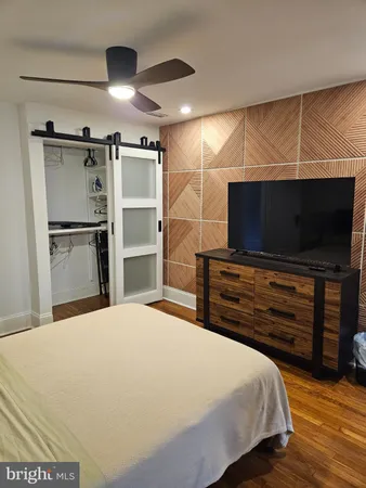 a bathroom with a sink a toilet a mirror and tub