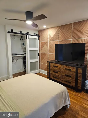 a bathroom with a sink a toilet a mirror and tub