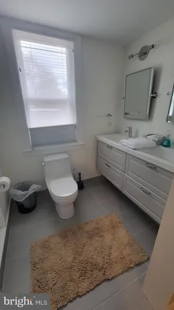 a bathroom with a shower a toilet and a sink