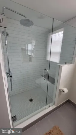 a bathroom with a sink and mirror with bathtub