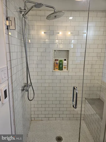 a view of a room with wooden floor and fan