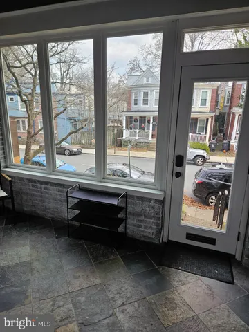 a living room with furniture a mirror and a fireplace