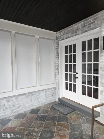 a kitchen with stainless steel appliances granite countertop a refrigerator a stove a sink a dining table and chairs