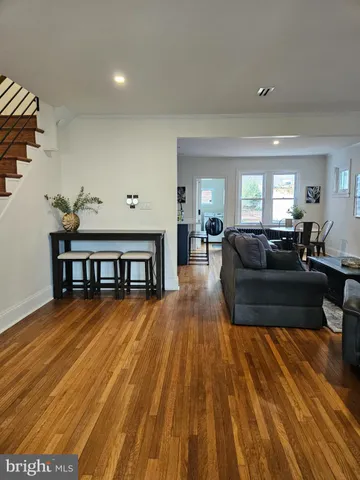 a kitchen with a dining table chairs and refrigerator