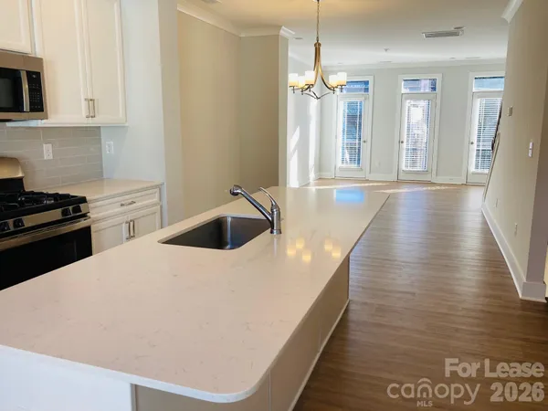 a kitchen with sink and cabinets