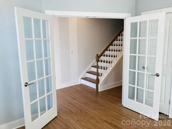 a view of entryway with wooden floor and stairs