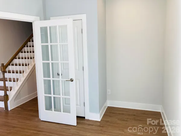 a view of a hallway with wooden floor and entryway