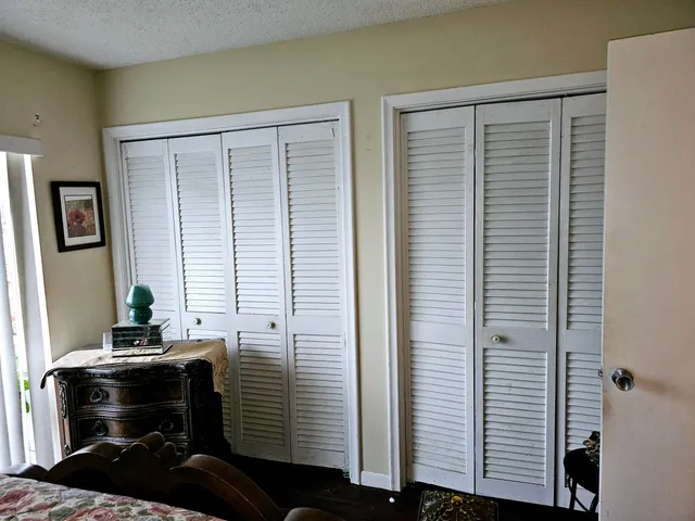 a view of a workspace room with wooden floor and windows