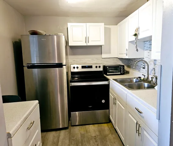 a kitchen with a refrigerator sink and stove
