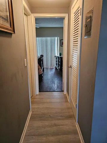 a view of a hallway view with wooden floor and staircase