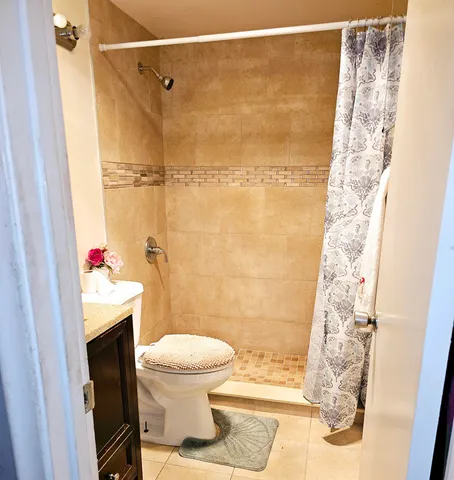 a bathroom with a toilet and a shower