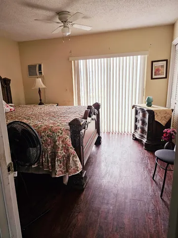 a bed room with a bed and a chair