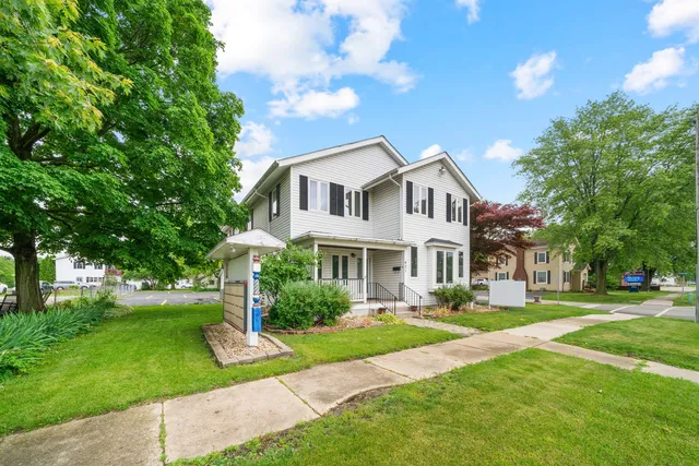 a front view of house with yard and green space