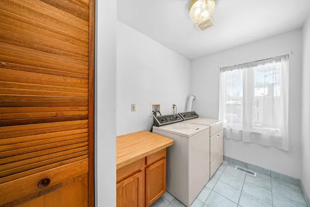 a kitchen with stainless steel appliances granite countertop a refrigerator and wooden cabinets