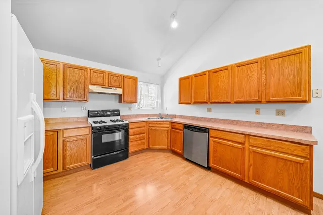 a view of a kitchen with a sink cabinets and a living room