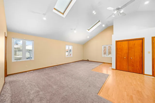 a view of an empty room with a kitchen