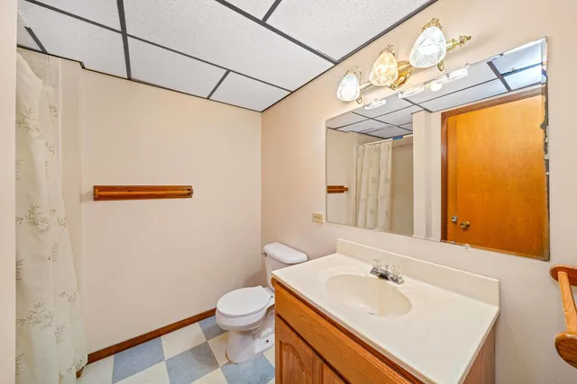 a view of a house with a big yard plants and large trees