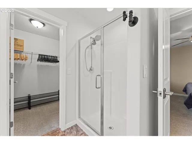 a living room with a flat screen tv a window and a flat screen tv