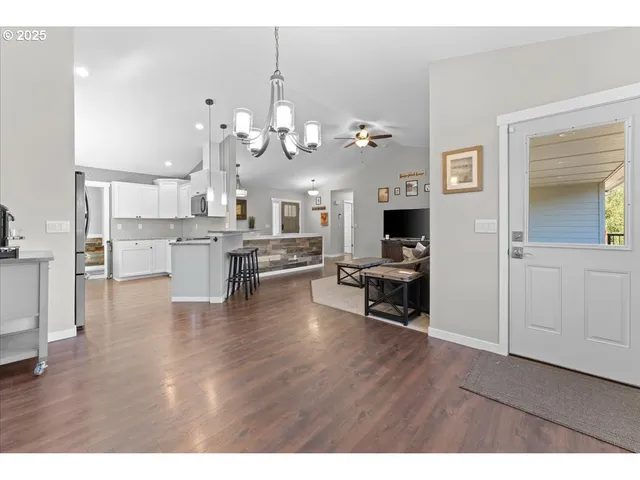 a view of a living room kitchen and a wooden floor