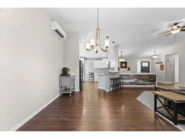 a living room with fireplace furniture and a wooden floor