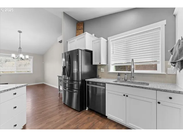 a kitchen with stainless steel appliances granite countertop a refrigerator and a sink