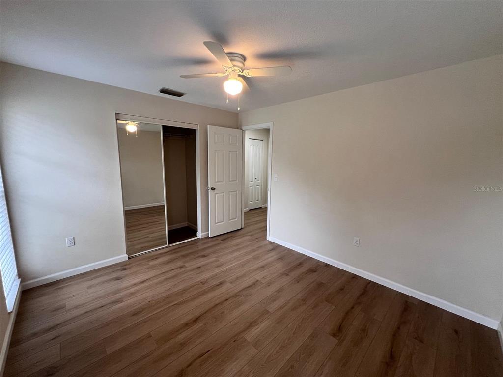 7020 Wentworth Way New Port Richey, FL 34655 - Photo 11 of 22 a view of an empty room with wooden floor