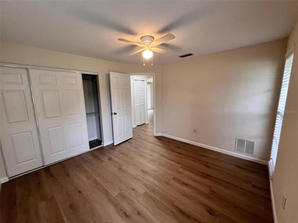 7020 Wentworth Way New Port Richey, FL 34655 - Photo 12 of 22 a view of an empty room with wooden floor