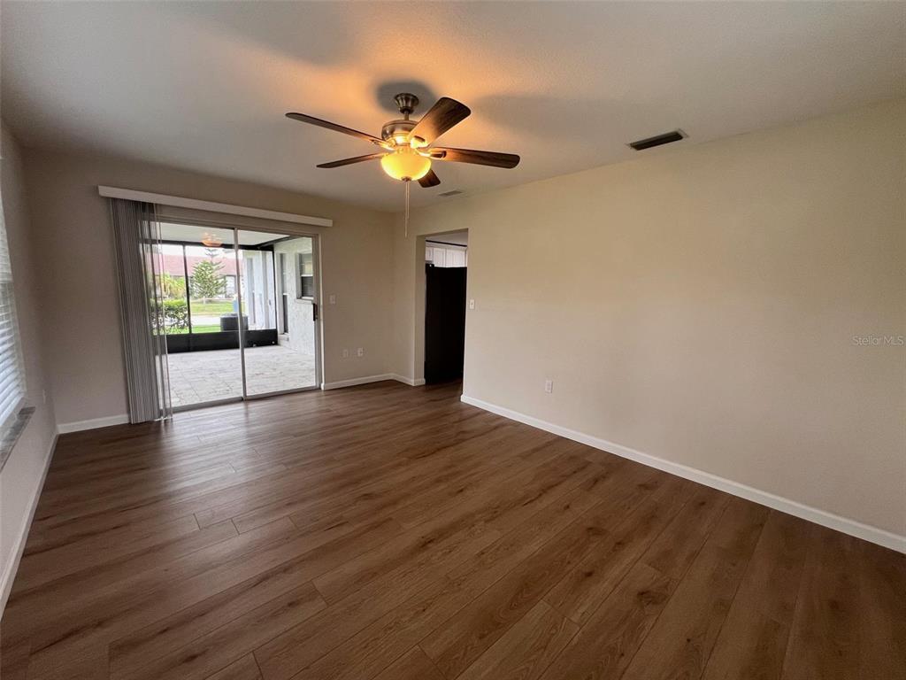 7020 Wentworth Way New Port Richey, FL 34655 - Photo 13 of 22 a view of an empty room with window and wooden floor