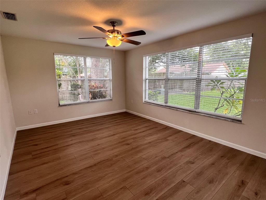 7020 Wentworth Way New Port Richey, FL 34655 - Photo 16 of 22 a view of an empty room with wooden floor and a window