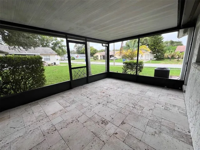a view of empty room with large windows