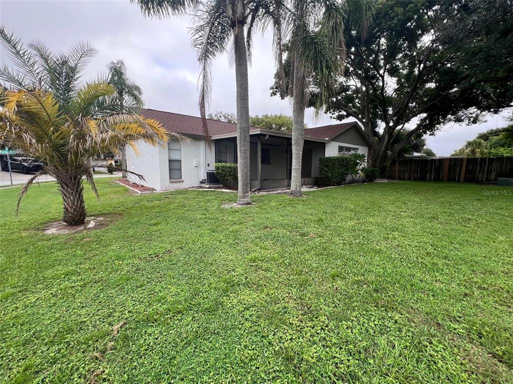 7020 Wentworth Way New Port Richey, FL 34655 - Photo 22 of 22 a front view of a house with a garden and trees