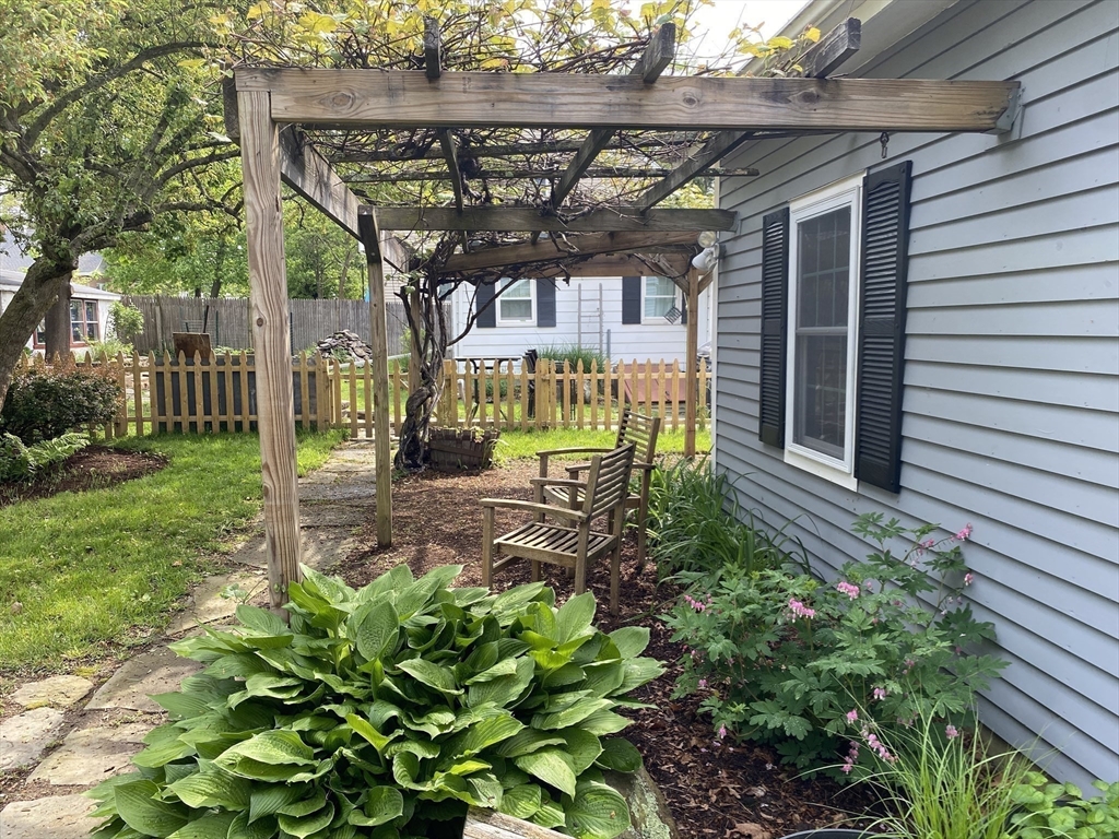 17 Jane Street Randolph, MA 02368 - Photo 13 of 18 a view of a chair and table in the garden