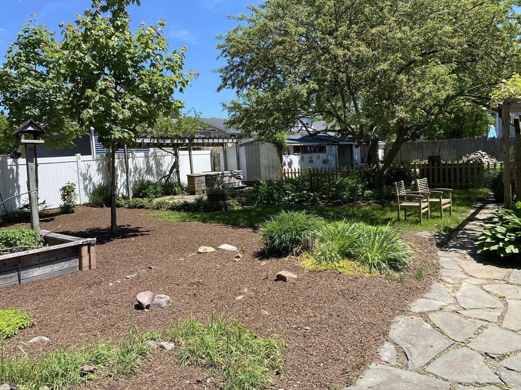 17 Jane Street Randolph, MA 02368 - Photo 16 of 18 a backyard of a house with yard and outdoor seating
