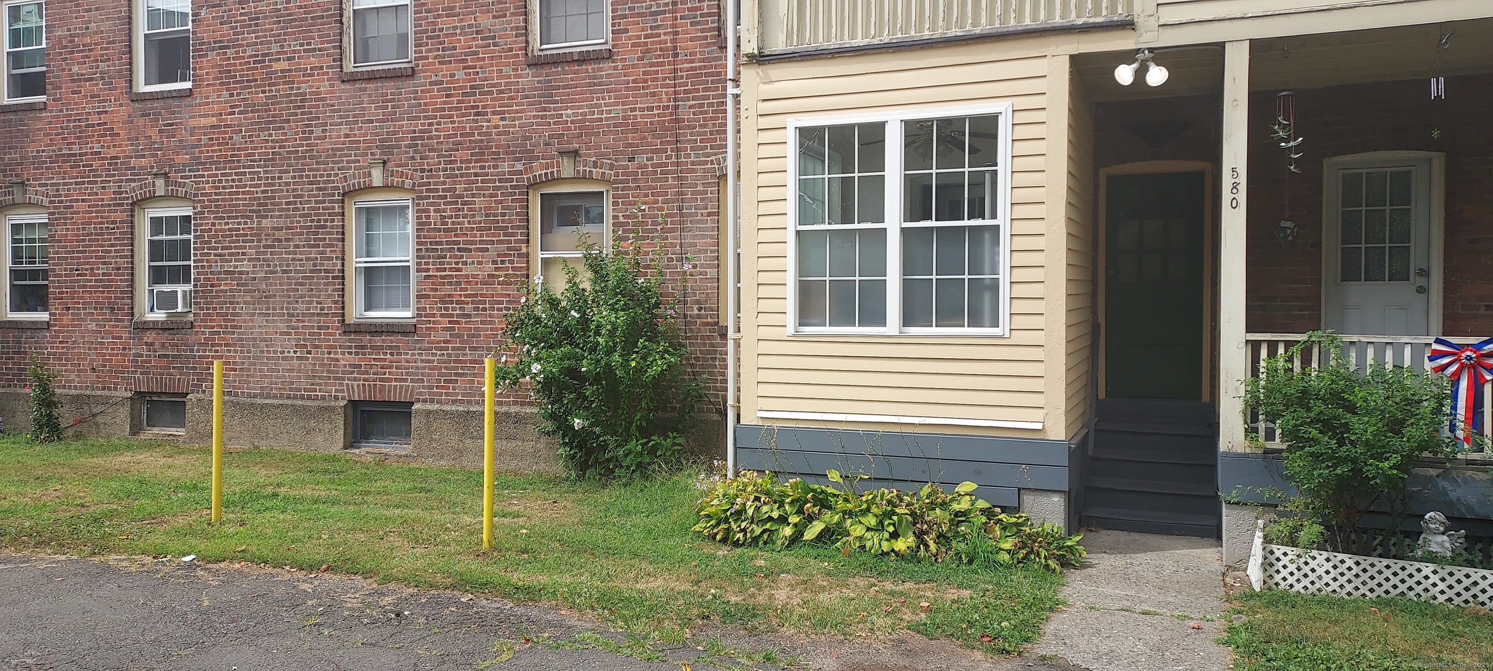 580 Wilmot Avenue, Unit 2 Bridgeport, CT 06607 - Photo 2 of 10 a view of a brick house with a yard and a large window