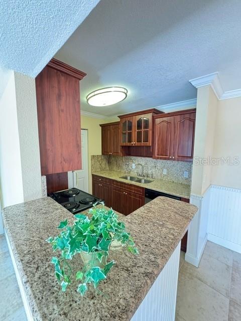 455 Alt 19, Unit 12 Palm Harbor, FL 34683 - Photo 3 of 12 a kitchen with kitchen island granite countertop wooden cabinets and a sink