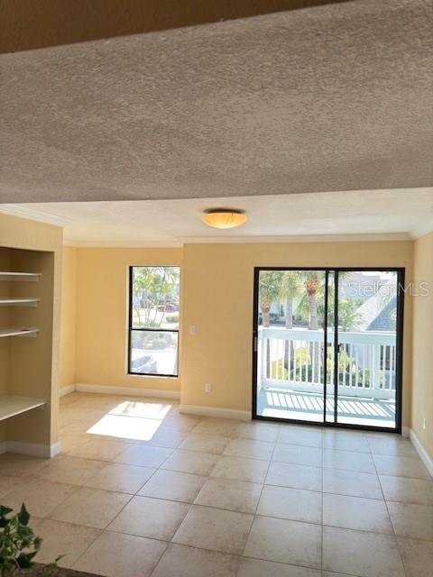 455 Alt 19, Unit 12 Palm Harbor, FL 34683 - Photo 6 of 12 a view of an empty room with a fireplace and a large window