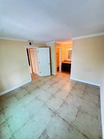 an empty room with windows and entrance